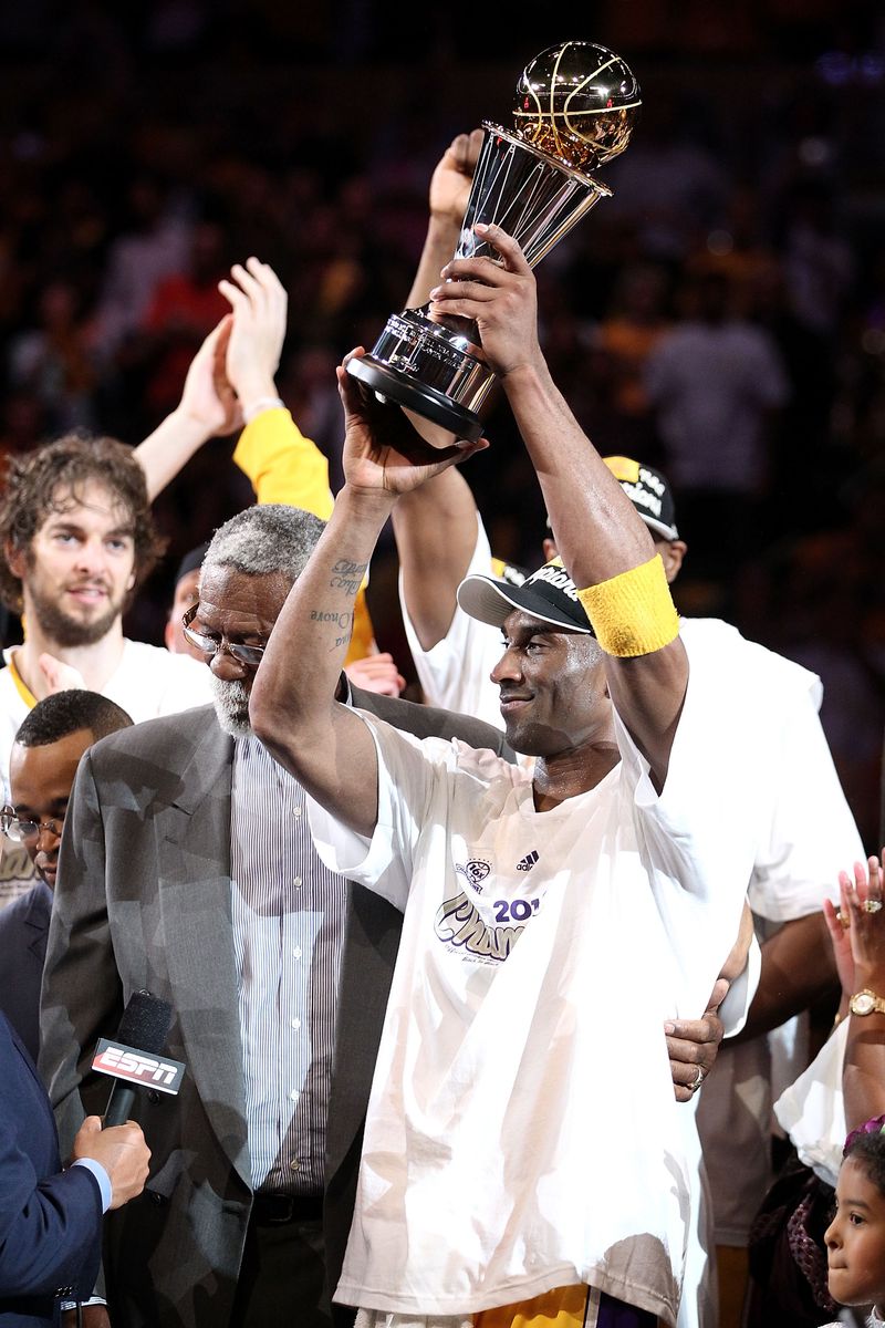 Kobe Bryant holding on to his fifth NBA championship trophy