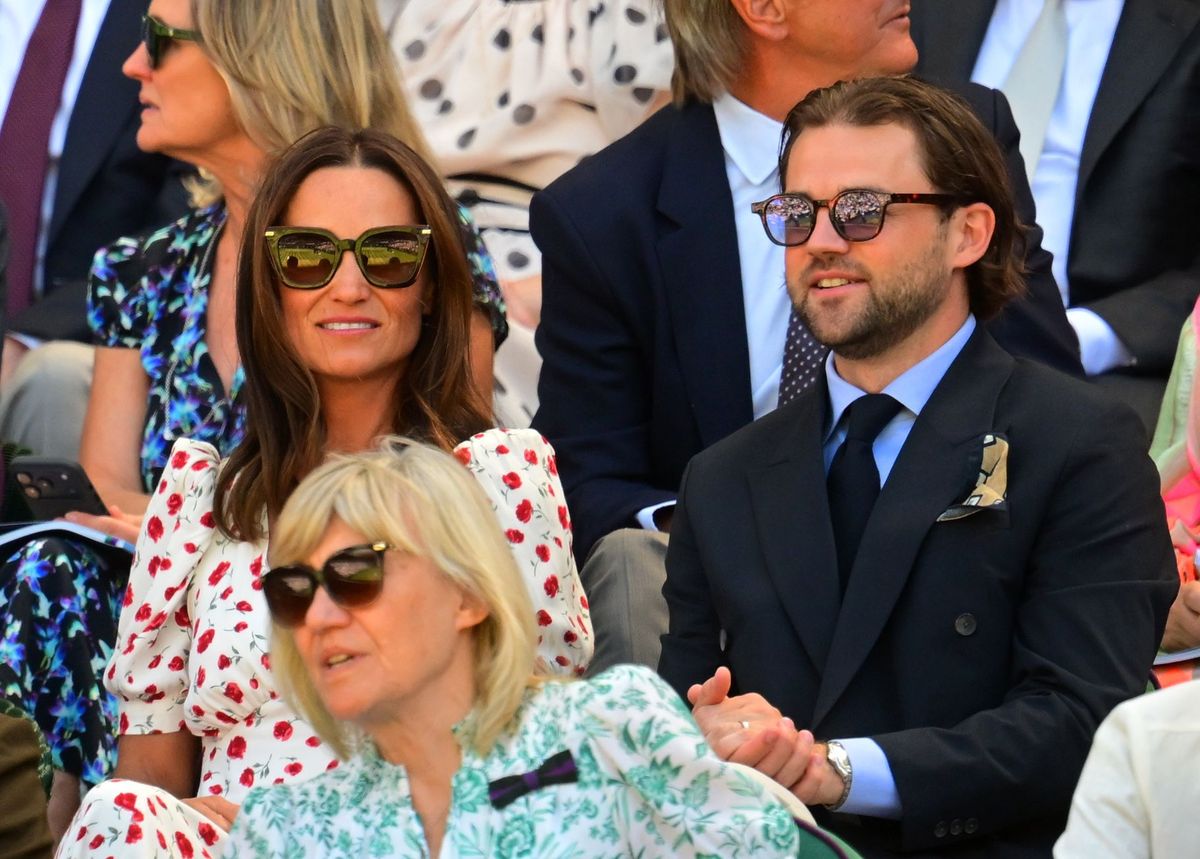Pippa Middleton completed her Wimbledon ensemble with a cream boater hat, Jimmy Choo sunglasses, and white pumps.