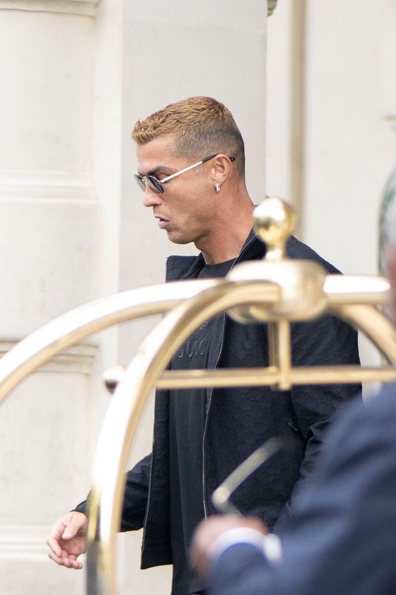 Cristiano Ronaldo was photographed at Paris Airport with blonde-copper hair as he stopped to greet supporters and sign autographs before continuing his journey. 