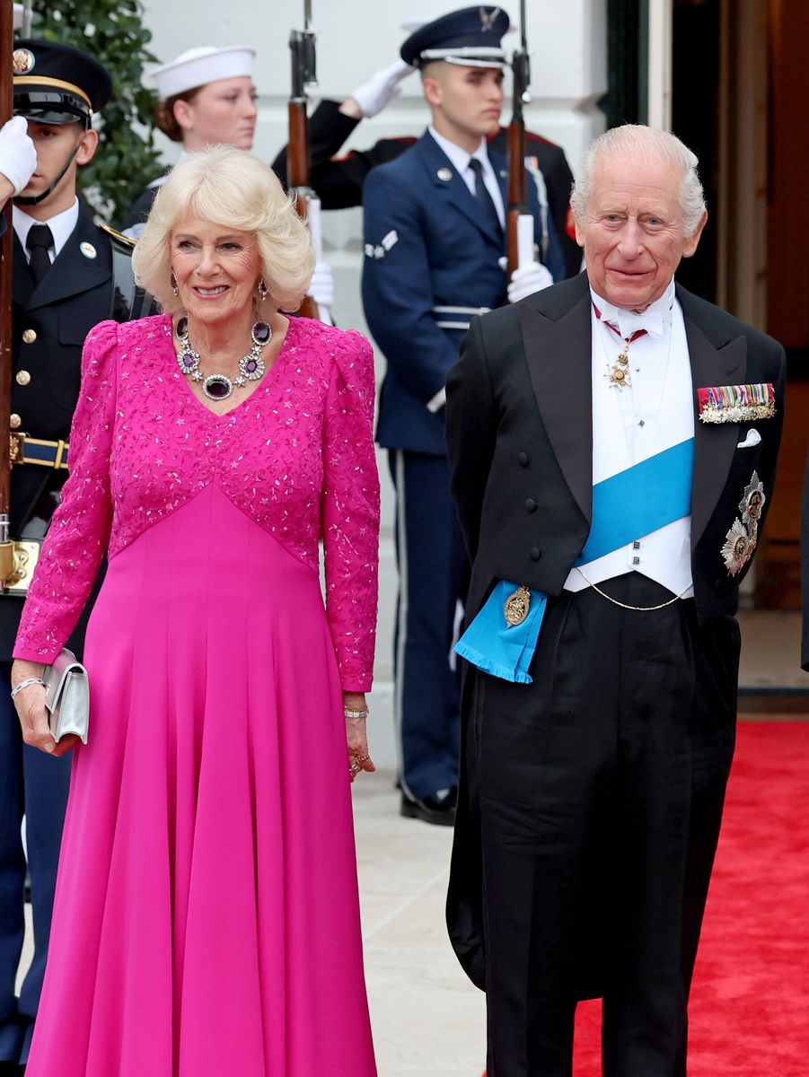Queen Camilla opted for a richer, more saturated expression of the trend. Her deep hot pink gown, designed by British couturier Fiona Clare, brought a regal vibrancy to the evening. 