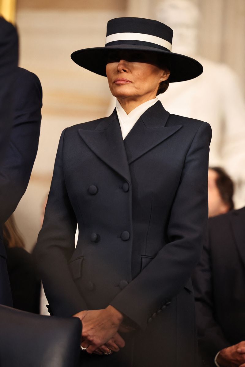First Lady Melania Trump bows her head in prayer during inauguration ceremony
