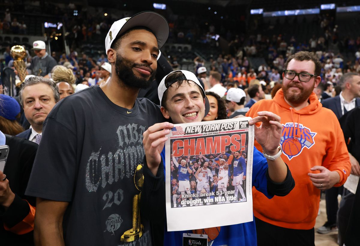 Timothee Chalamet celebrates with Mikal Bridges #25 of the New York Knicks after the victory against the San Antonio Spurs in Game Five.
