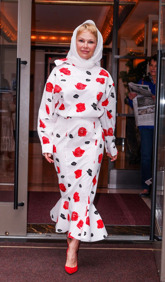 Pamela Anderson steps out of her hotel in New York City looking stunning in a white Marni dress.