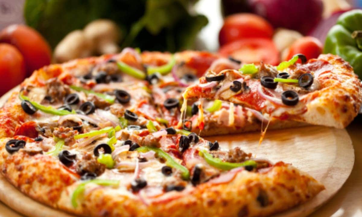 Family or friends pizza party. Flat lay of people eating different types of pizza and drinking red wine over rustic wooden table, top view.