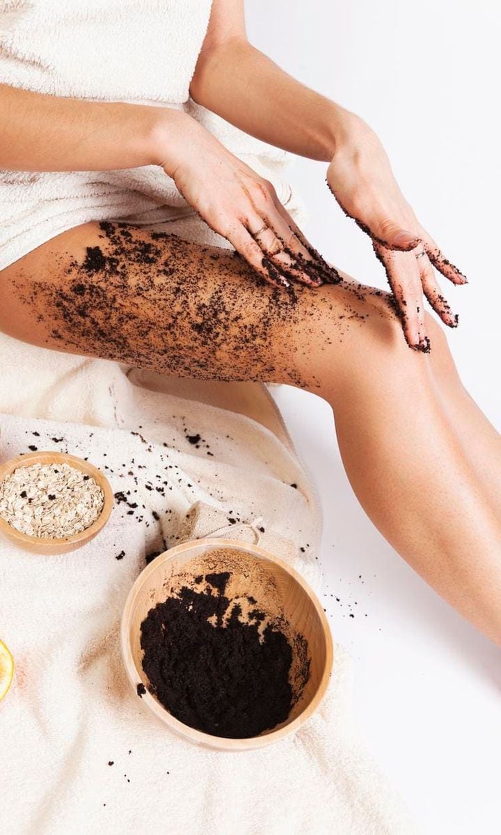 Woman exfoliating her skin