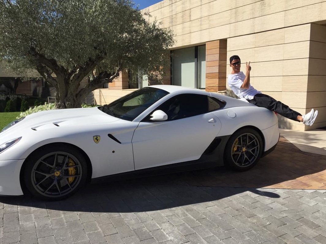 Cristiano Ronaldo surrounded by his luxury car collection.