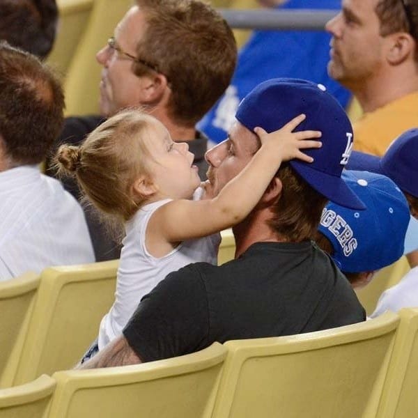 British soccer star David has also introduced his daughter to the American pastime of baseball although here she seems to find her dad's cap more interesting than the game between the Chicago Cubs and Los Angeles Dodgers in August 2013.
Photo: Getty Images