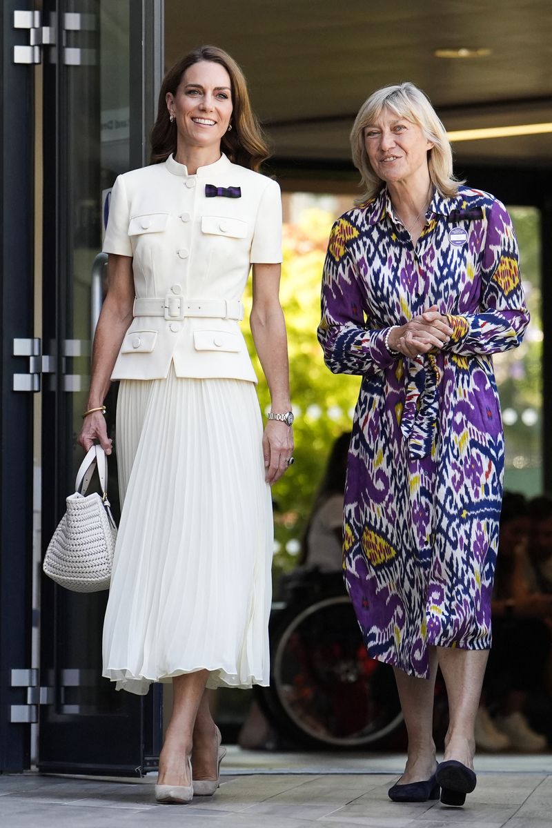Britain's Catherine, Princess of Wales (L) speaks with Chair of the All England Lawn Tennis and Croquet Club Board Deborah Jevans upon her arrival to attend the women's singles final tennis match on the thirteenth day of the 2025 Wimbledon Championships at The All England Lawn Tennis and Croquet Club in Wimbledon, southwest London, on July 12, 2025. (Photo by Jordan Pettitt / POOL / AFP) / RESTRICTED TO EDITORIAL USE (Photo by JORDAN PETTITT/POOL/AFP via Getty Images)          