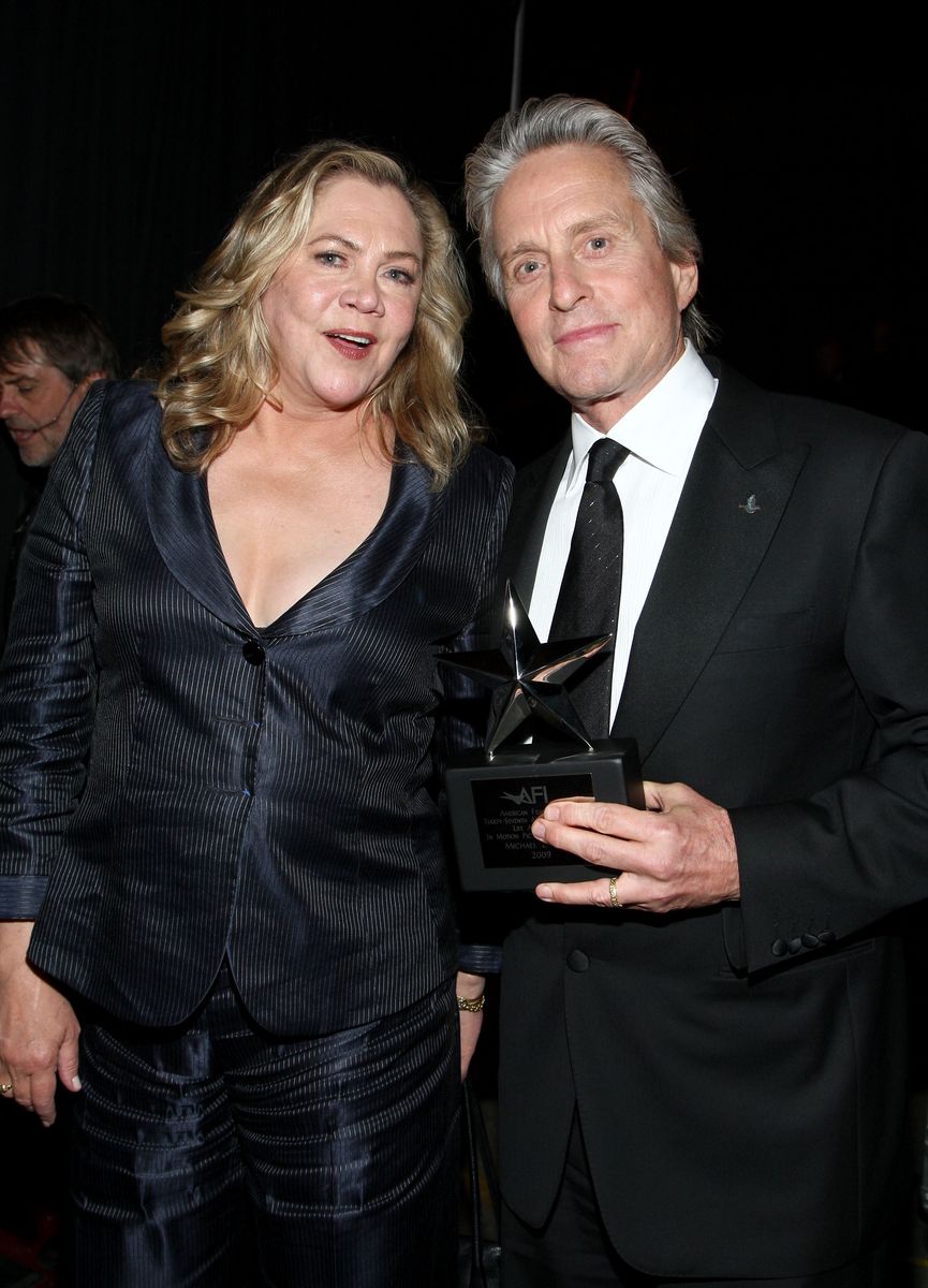 Actress Kathleen Turner (L) and actor Michael Douglas, recipient of the Life Achievement In Motion Pictures and Television award and actress pose backstage at the AFI Life Achievement Award