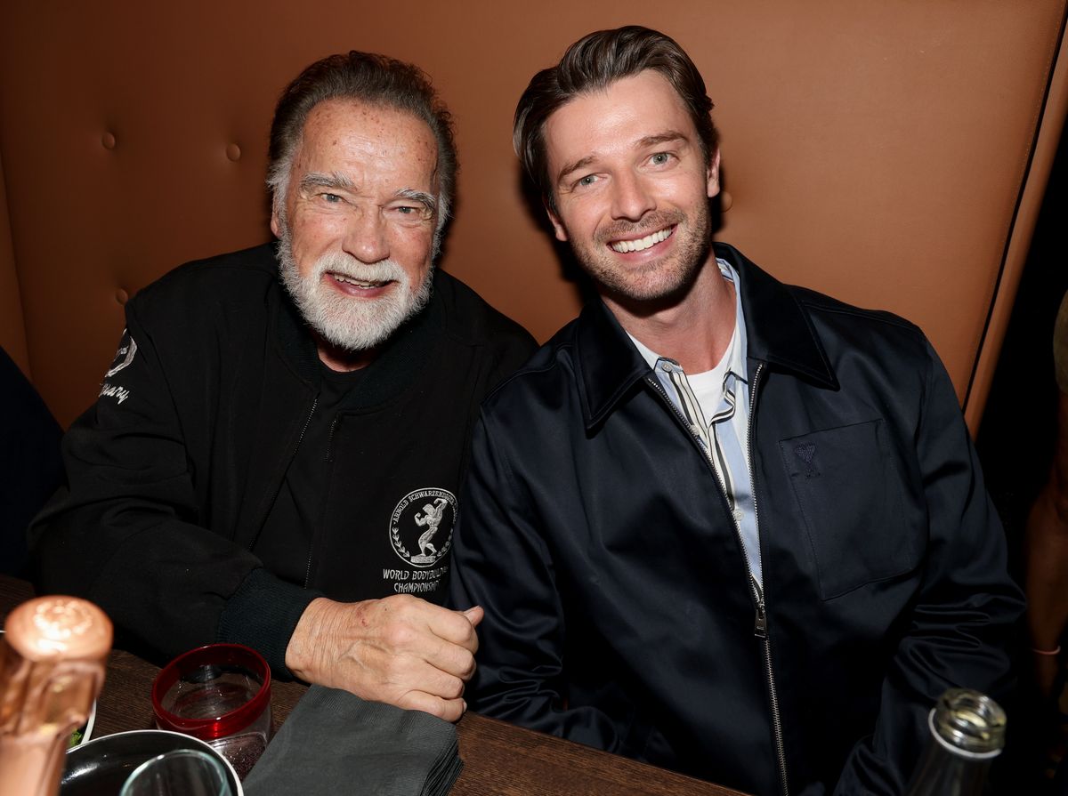 Patrick and Arnold Schwarzenegger at the opening of Planet Hollywood in New York