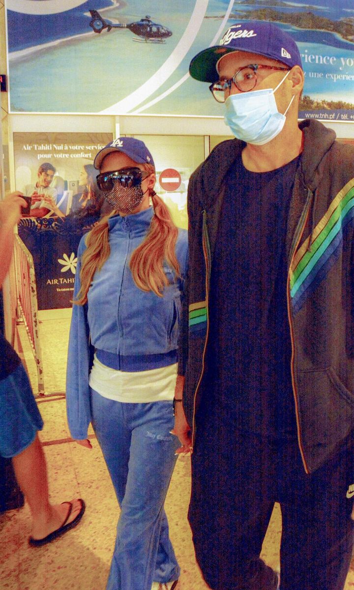Paris Hilton and Carter Reum hold hands as they arrive in Tahiti.