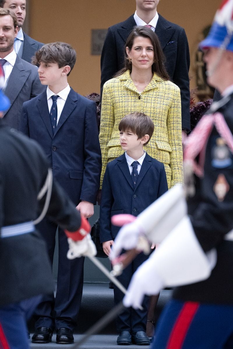 She completed the outfit with semi-sheer black tights, a trend resurfacing this season, and classic heels with an ankle strap