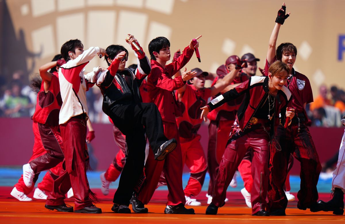 BTS performs a tournament-themed version of “Dynamite” during the 11-minute halftime production.