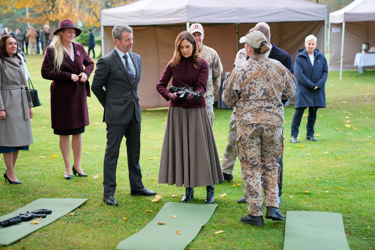 Mary of Denmark wields a rifle at Adazi Gymnasium in Adazi, Latvia, on October 29, 2025. During the visit, the Royal Couple observes civil defense education, which is a mandatory subject in secondary education.