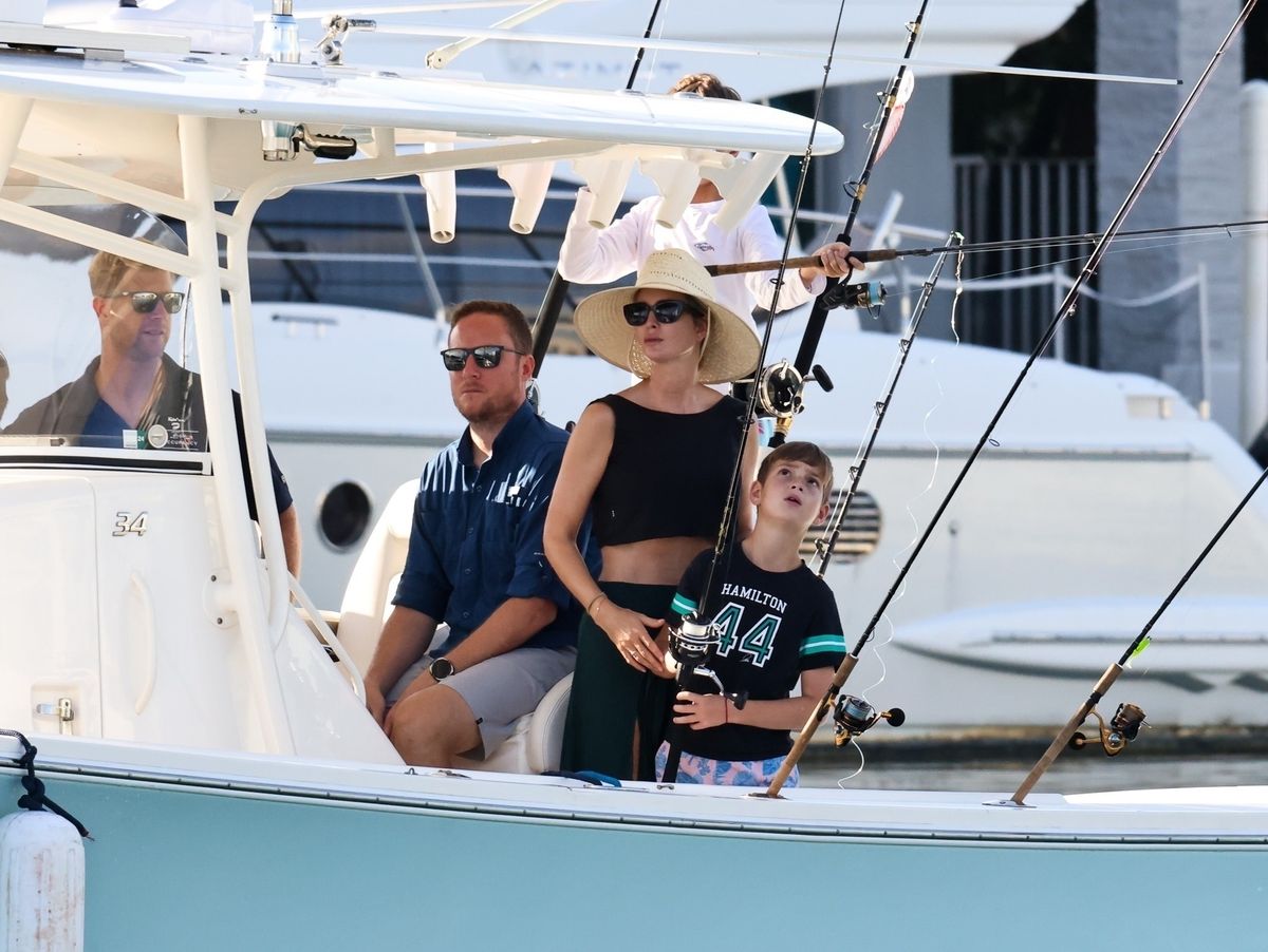 Ivanka stood by her son Theo as he fished in the water