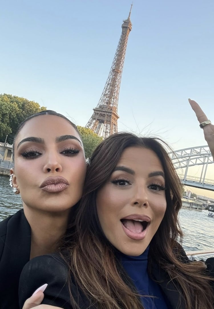 Kardashian and Longoria posing in front of the Eiffel tower