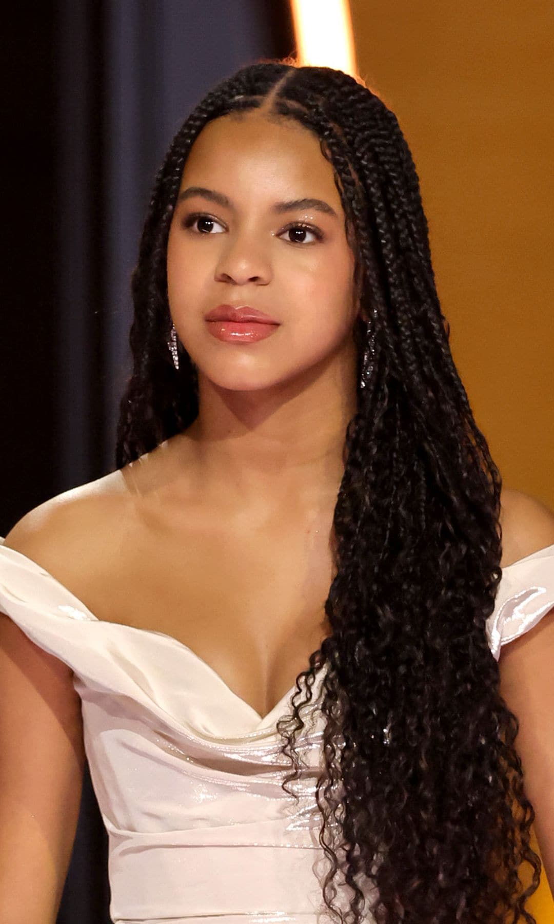 Blue Ivy towers over Beyoncé in green pleated skirt and statement jewelry during fun night out