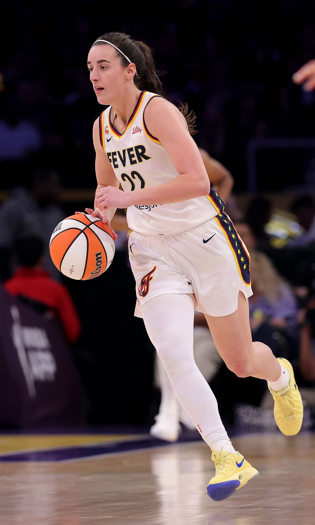 Caitlin Clark #22 of the Indiana Fever brings the ball up court during the fourth quarter of the game against the Los Angeles Sparks 