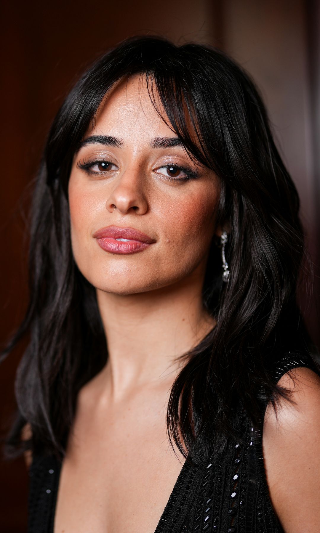 Camila Cabello poses in semi-sheer blouse and micro shorts at the French Riviera