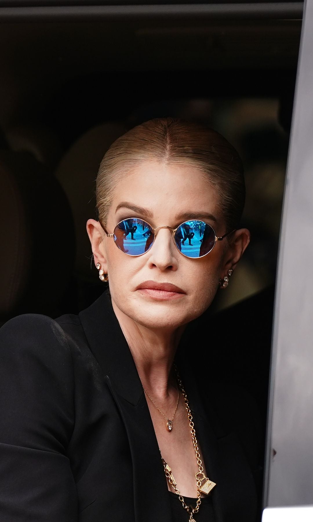 Kelly wore round, purple tinted glasses, which her father used to wear
