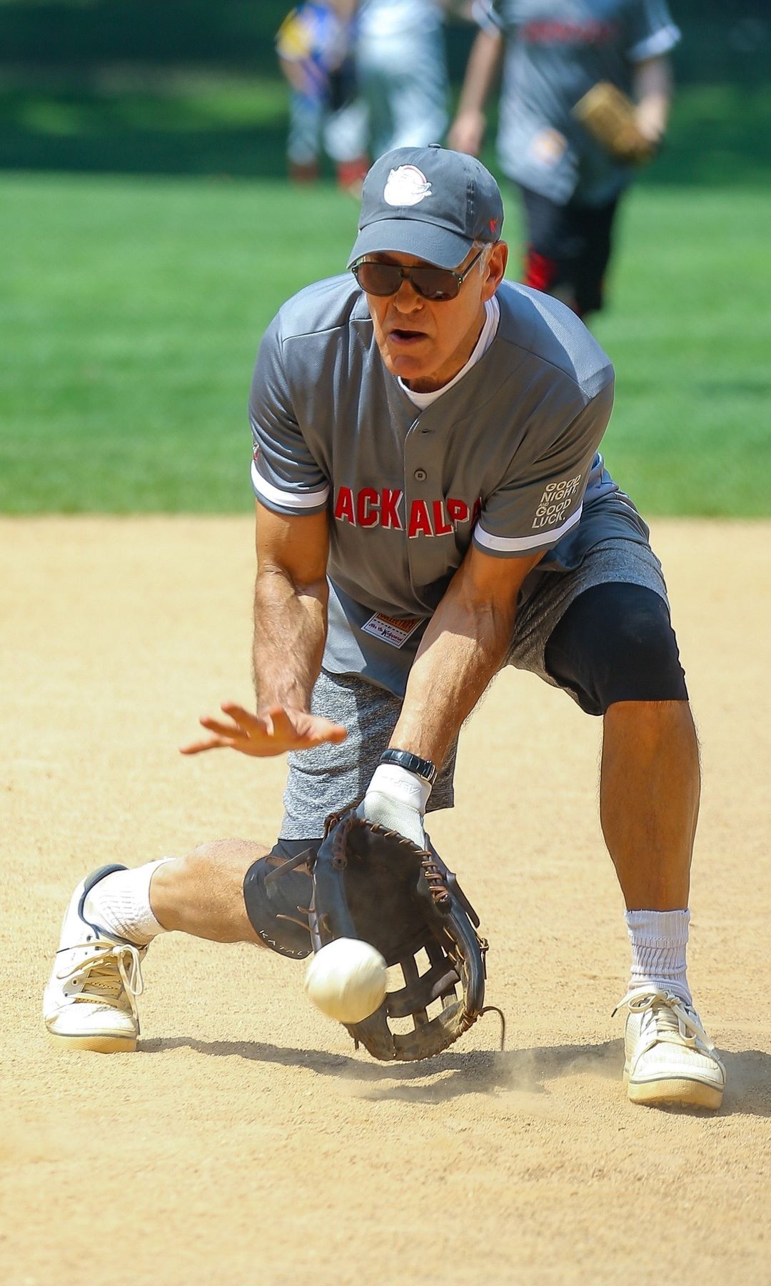 Clooney looking focused while playing softball