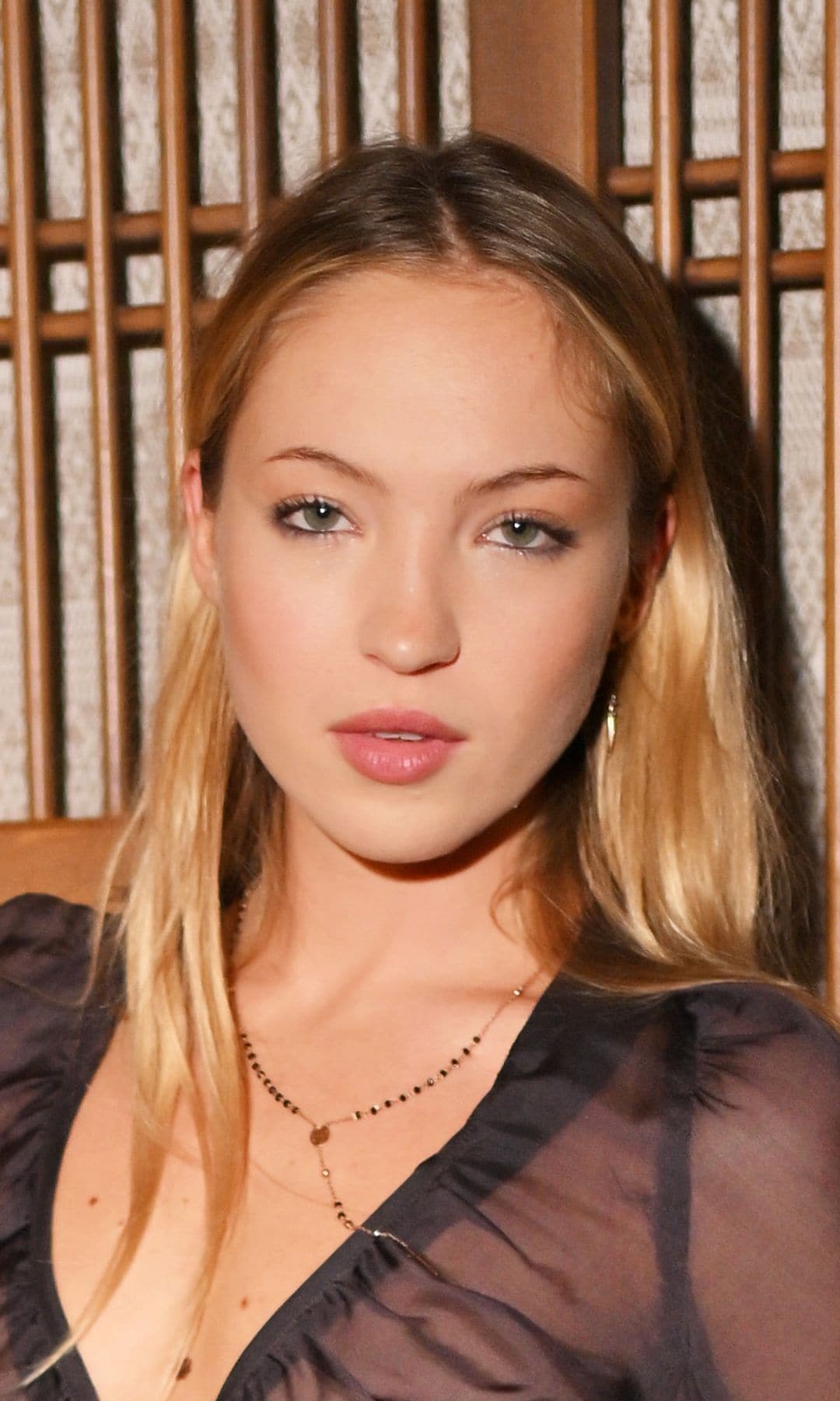 Lila Moss poses in strapless feathered minidress and pointed toe heels in latest runway moment