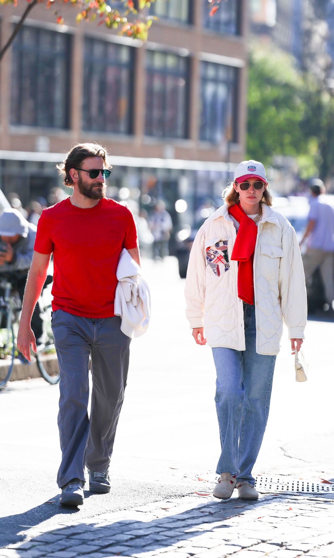 Bradley Cooper and Gigi Hadid matching in red, on November 2024, in New York
