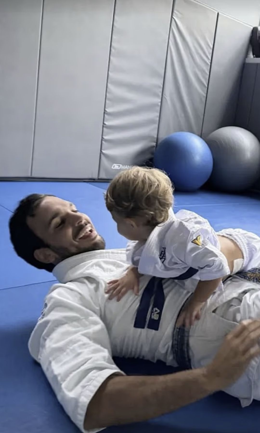 Joaquim and his son wearing matching gis