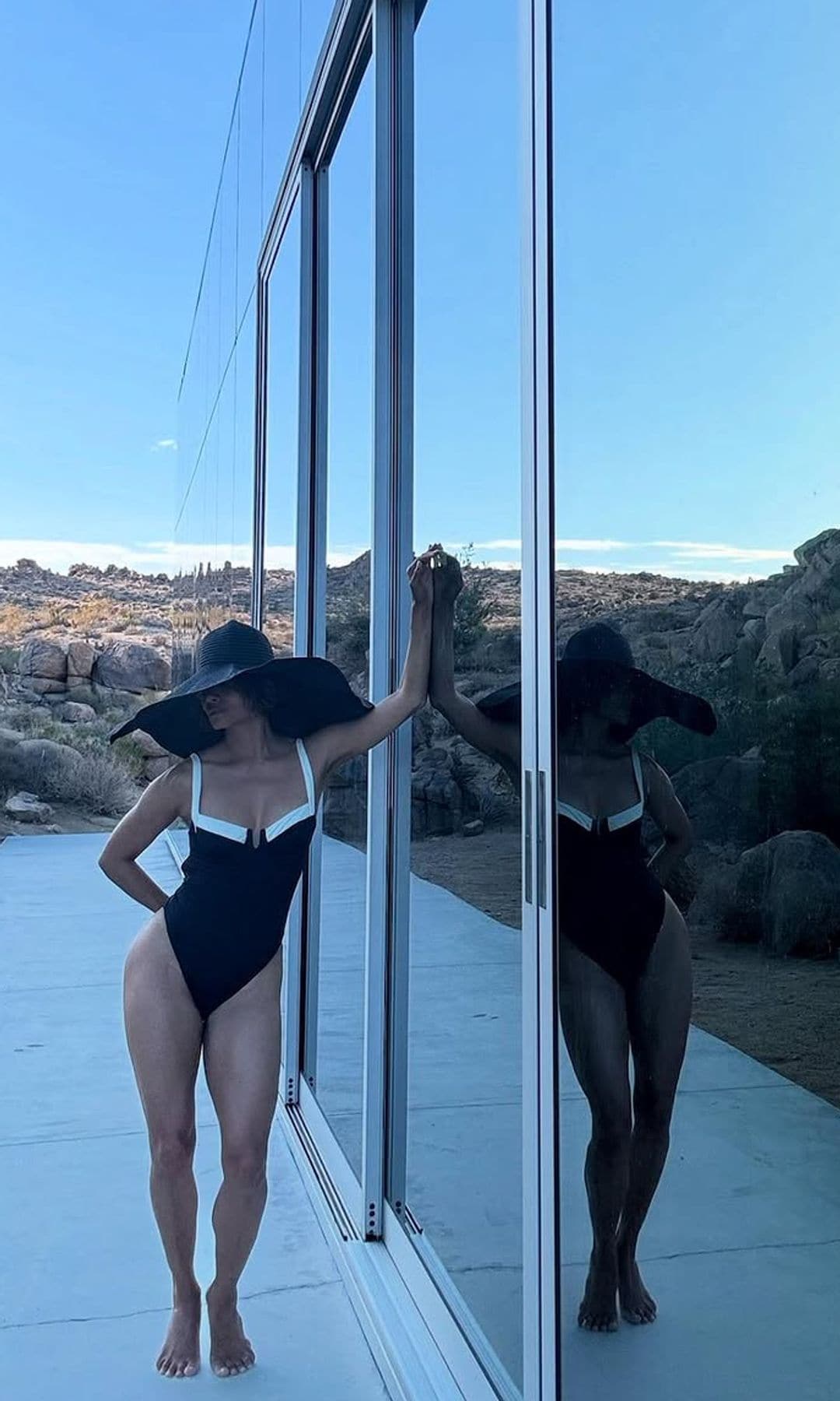 Halle Berry stuns in a plunging one-piece bikini with a giant sun hat during a desert getaway