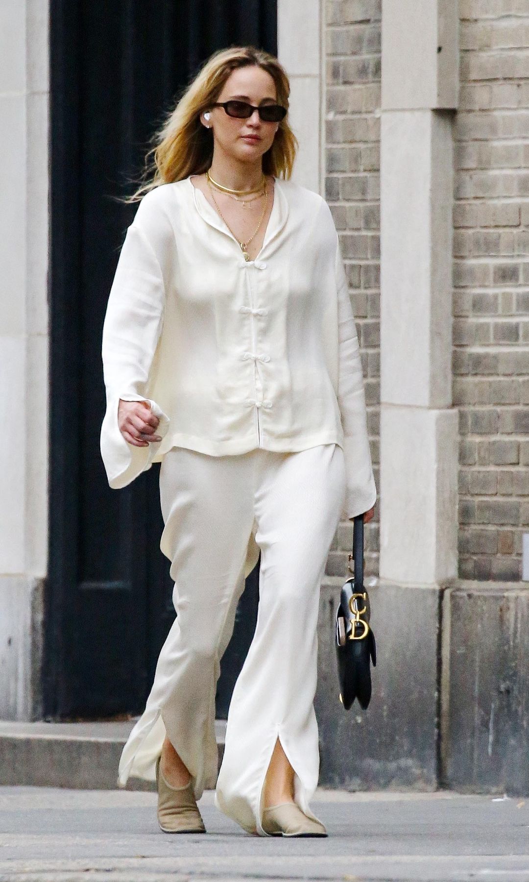 Jennifer Lawrence was spotted strolling through New York looking effortlessly stylish in a creamy satin blouse and matching trousers. 