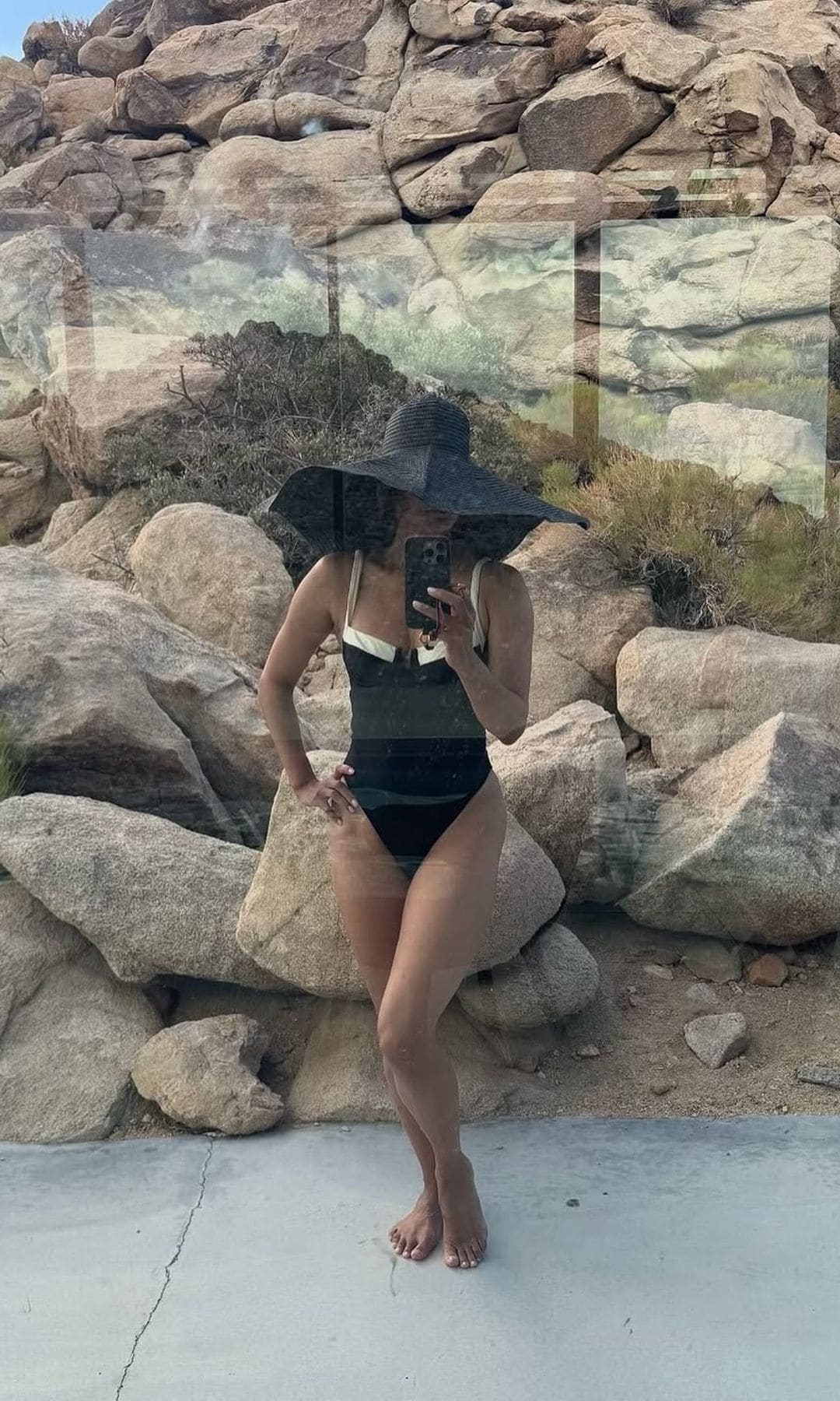 Halle Berry stuns in a plunging one-piece bikini with a giant sun hat during a desert getaway