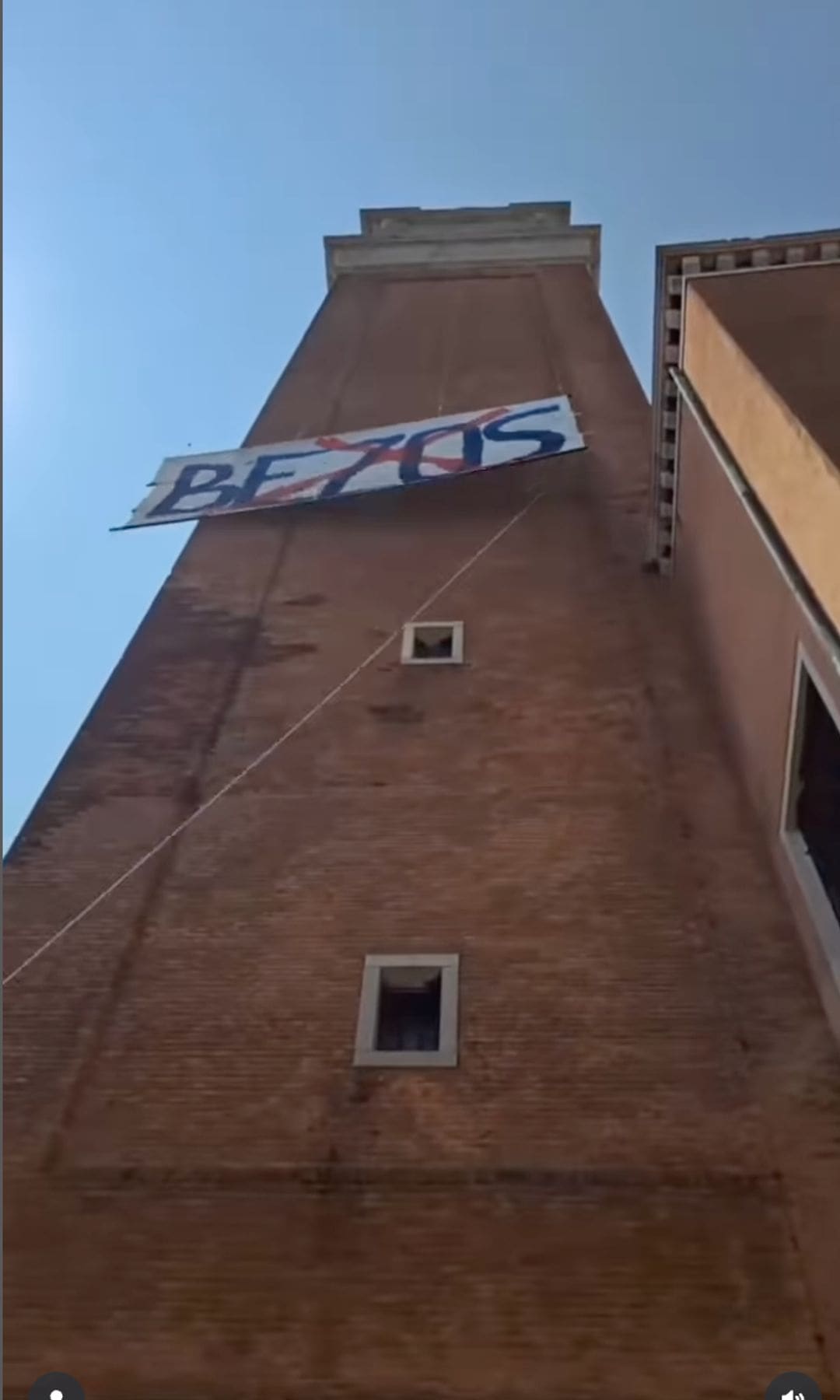 Some people hung a large banner outside a bell tower