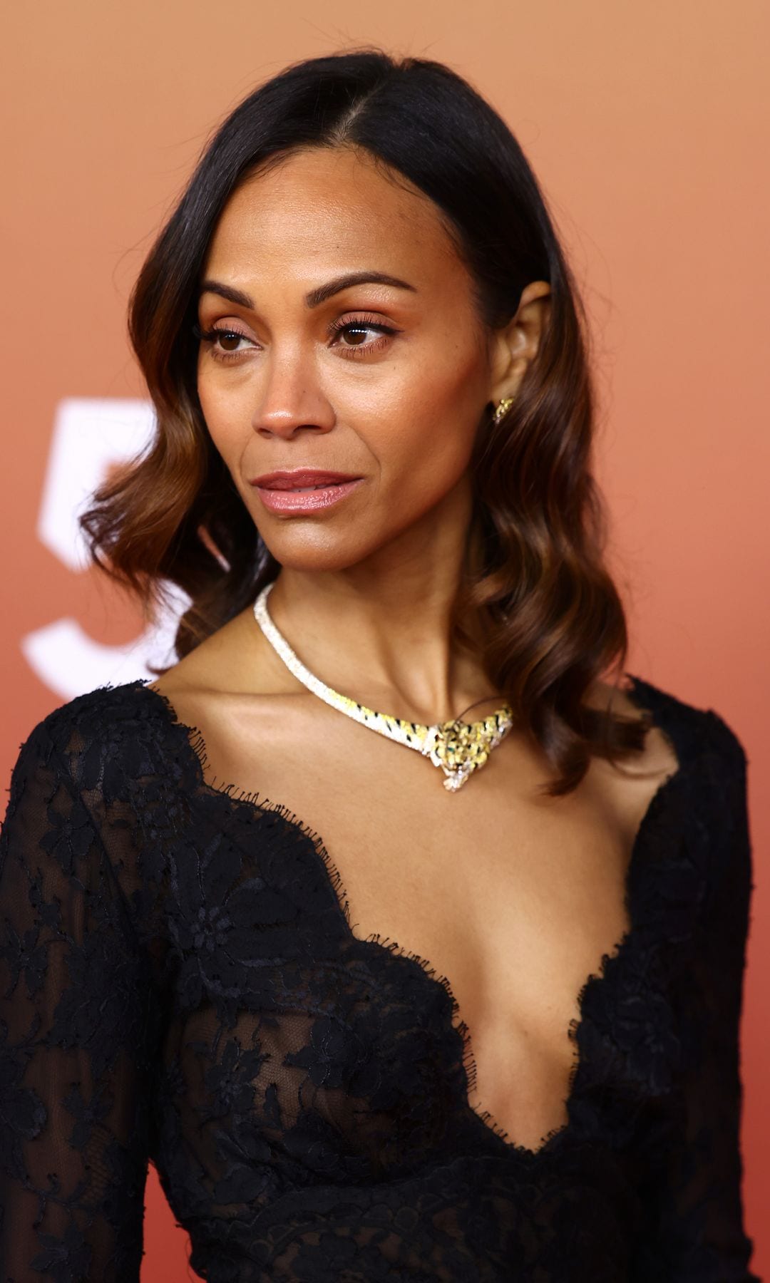 Zoe Saldaña turns heads in sculptural leather silhouette and gold jewelry for ‘Avatar: Fire and Ash’