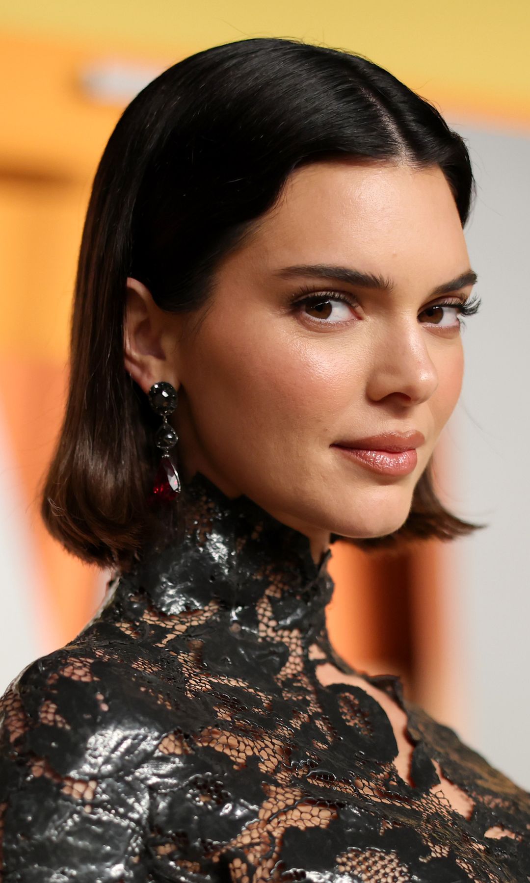 Kendall Jenner channels 90s couture in vintage minidress with thigh-high slit and sheer neckline