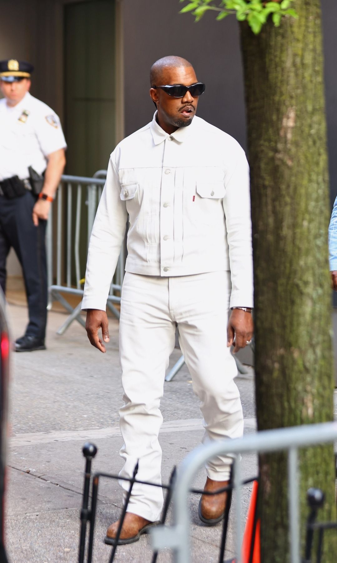 West wore an all white denim outfit at his goddaughter's graduation in New York