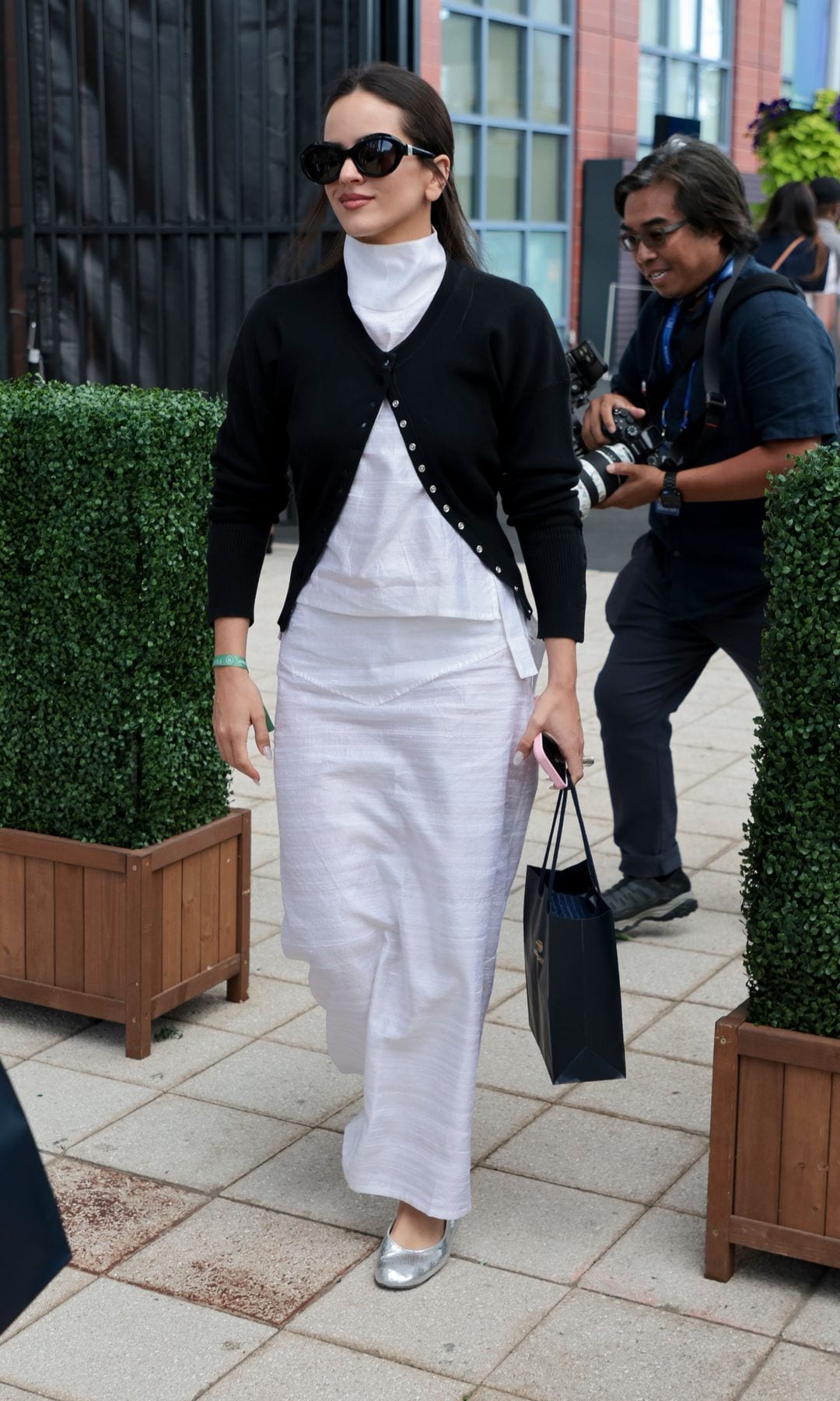 Rosalia wore a basic yet elegant outfit made up of a white dress and a navy sweater