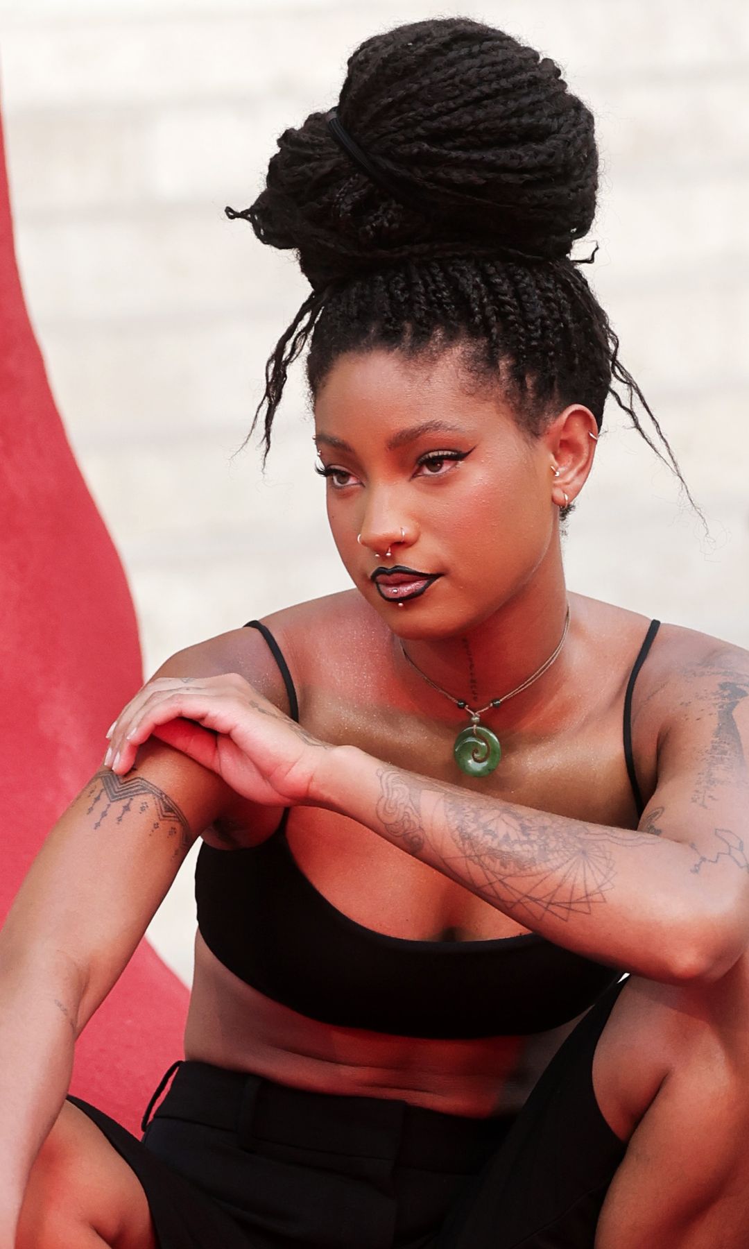 Willow Smith turns heads in crop top, tailored shorts and sculptural braided updo at Paris Fashion Week