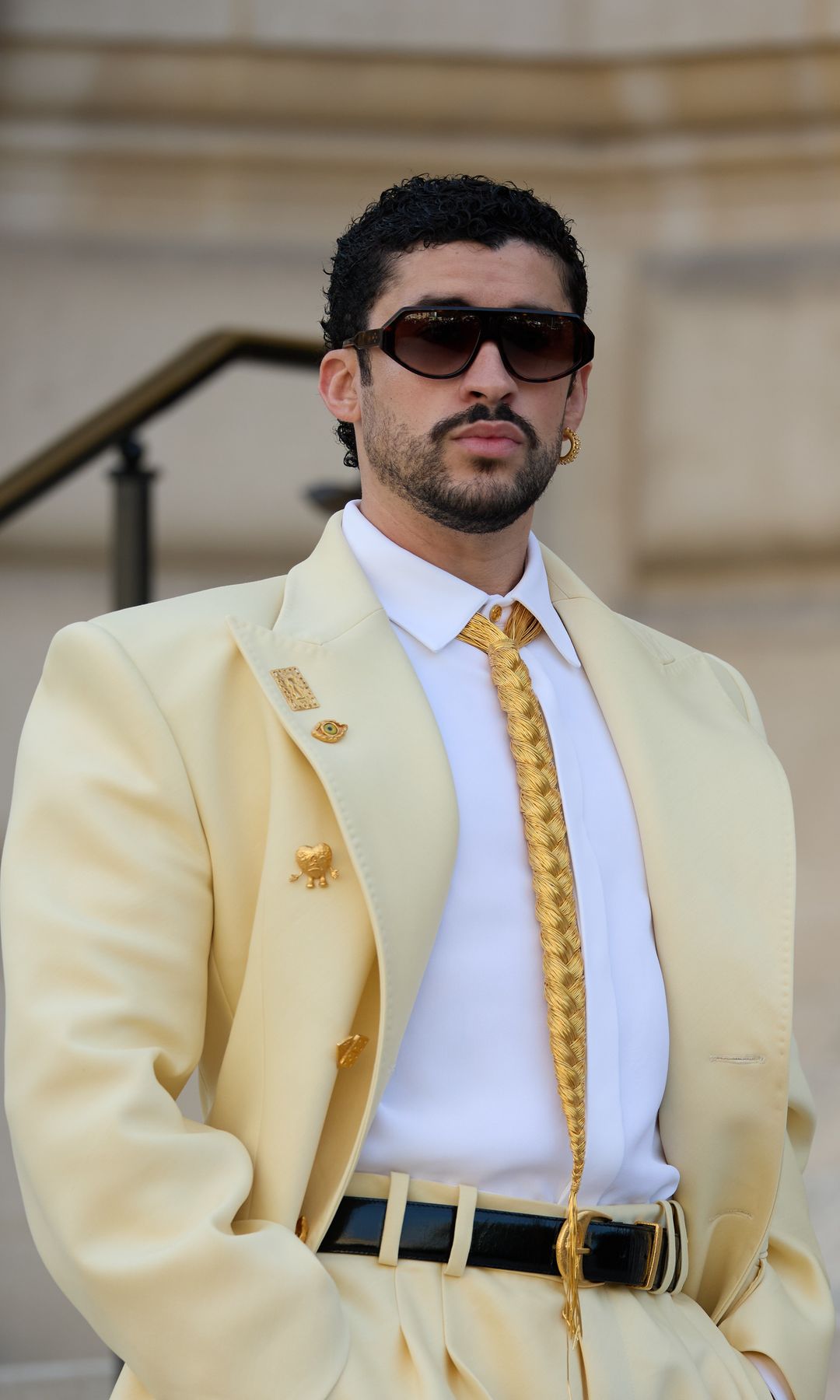 The gold braided tie, a growing signature detail during Roseberry's tenure at the French fashion house.
