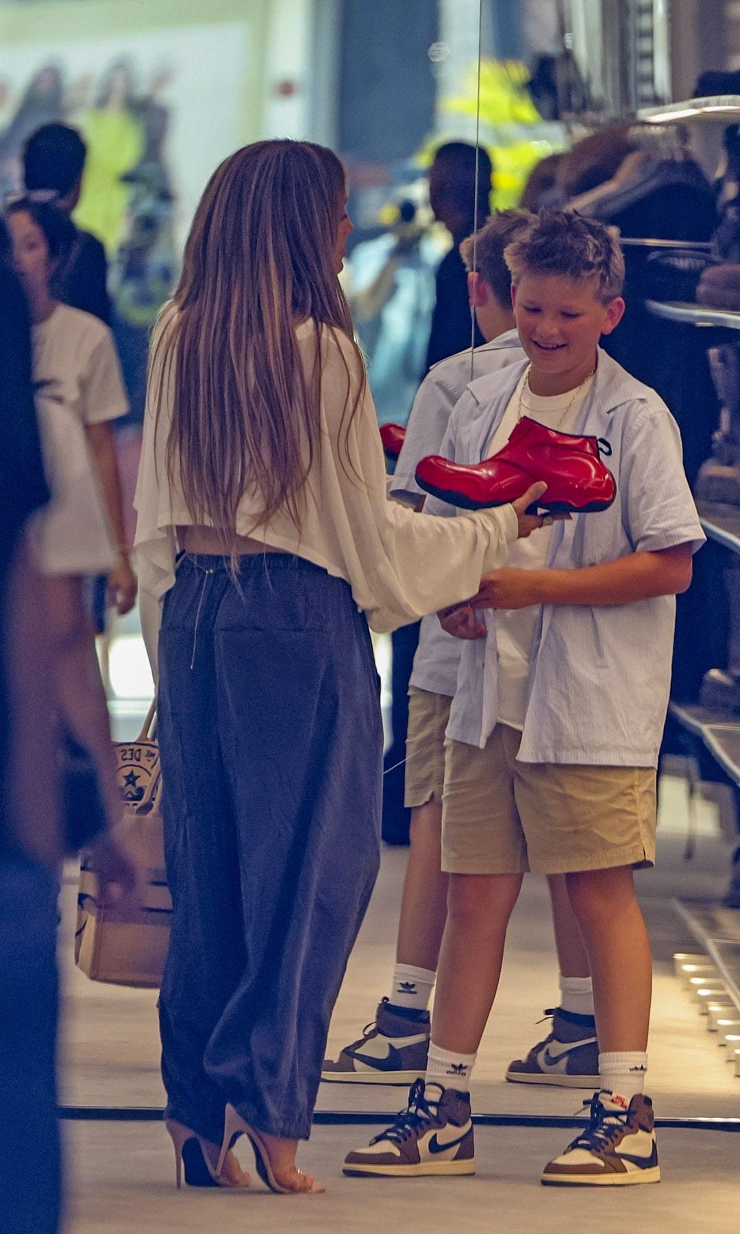 Photos captured Samuel grinning as Lopez held out the eye-catching footwear.
