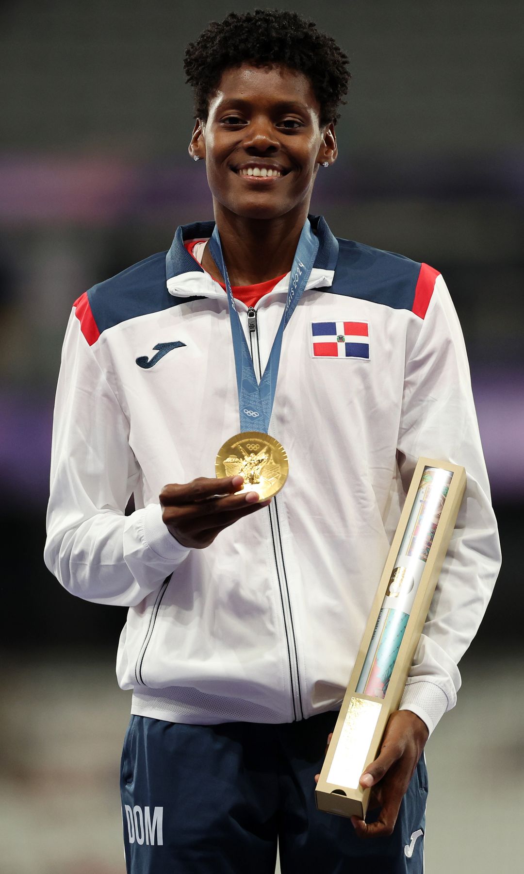 Gold medalist Marileidy Paulino of Team Dominican Republic celebrates on the podium during the Women's 400m medal ceremony on day fourteen of the Olympic Games Paris 2024 at Stade de France on August 09, 2024 in Paris, France. (Photo by Patrick Smith/Getty Images)