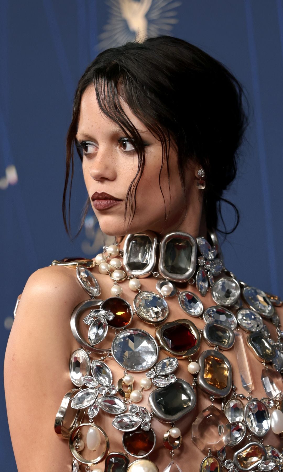 Jenna Ortega poses in jewel-encrusted naked top and bleached eyebrows honoring Isabella Rosellini’s iconic role