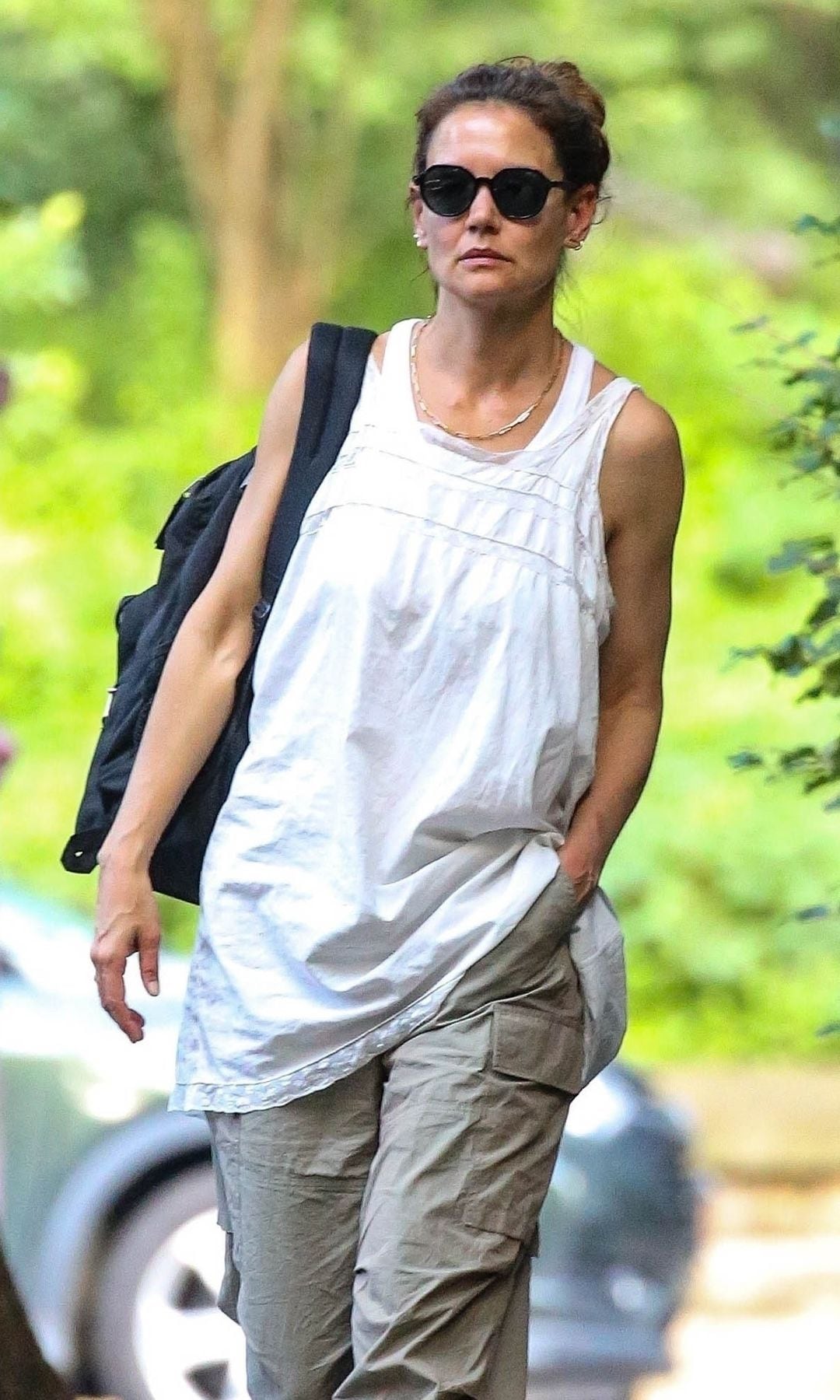 Katie Holmes kept her ensemble baggy and comfy with a loose white tank top, cargo pants, and black flats