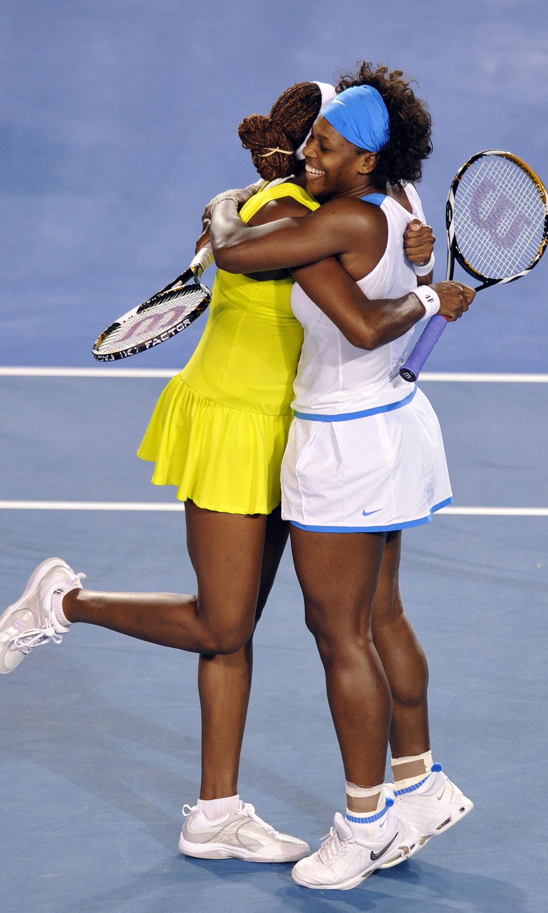 Serena (R) and Venus Williams of the US embrace after victory in their women's doubles final match against Ai Sugiyama of Japan and Daniela Hantuchova of Slovakia