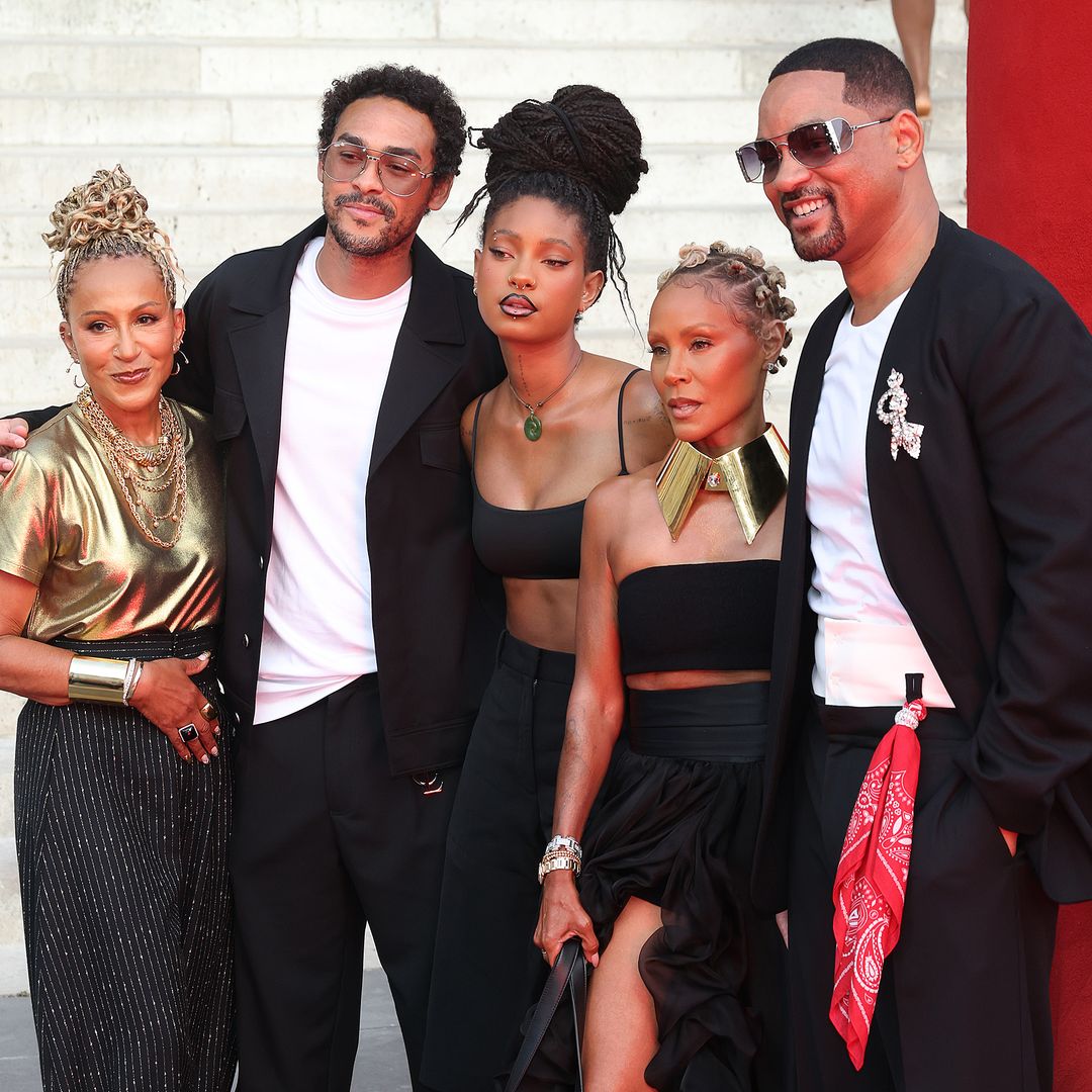 Will Smith and Jada Pinkett Smith pose in coordinated looks with Willow and Trey Smith to support Jaden Smith at Paris Fashion Week