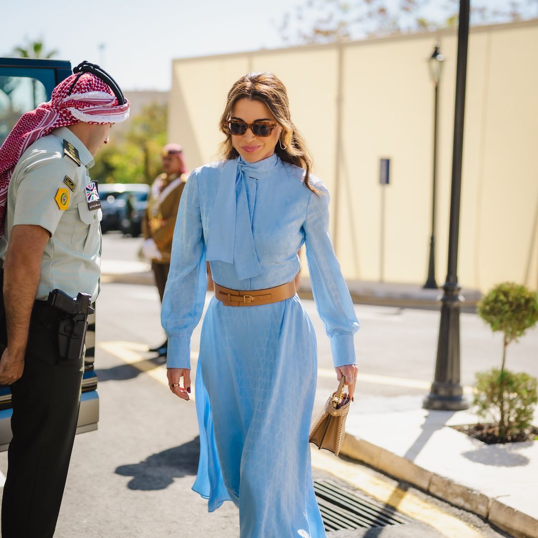 Queen Rania of Jordan’s blue look: silk dress, Lebanese shoes, and iconic bag at the opening of the Hashemite Parliament