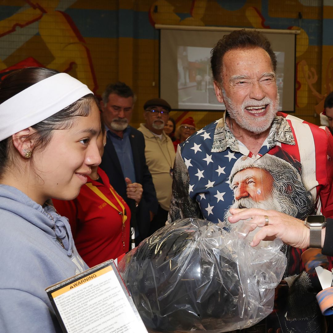 Arnold Schwarzenegger celebrates Christmas early, dressing up and giving presents to kids