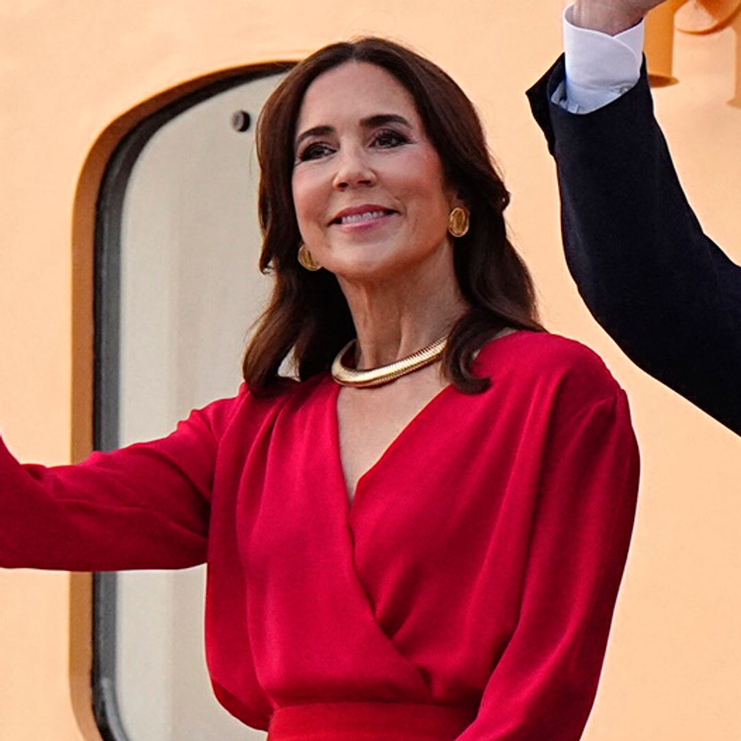 Queen Mary turns heads in a vibrant scarlet dress and romantic cinched look during Denmark's royal summer cruise