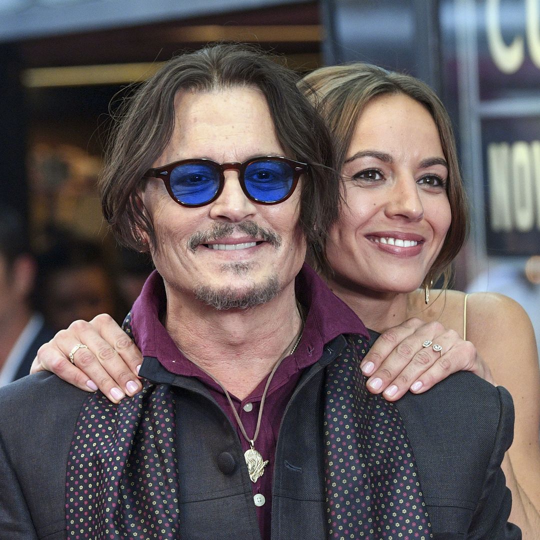 Johnny Depp kisses Antonia Desplat at the premiere of his new movie