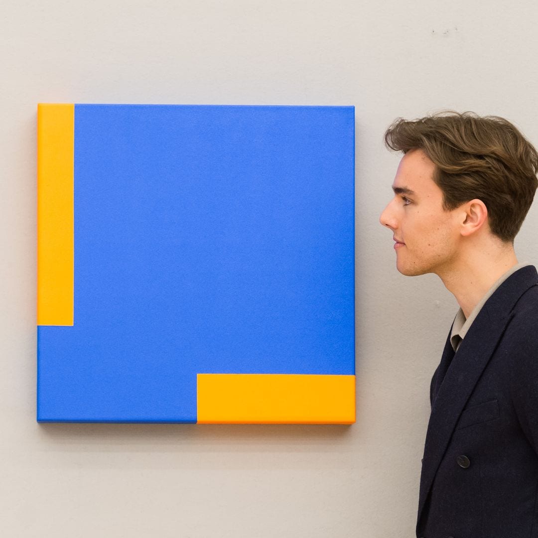 A staff member looks at Untitled (2013) by Carmen Herrera (est.: 150,000 - 200,000) during a photo call for Bonhams' Contemporary Art Sale, on April 22, 2021 in London, England. (Photo credit should read Wiktor Szymanowicz/Future Publishing via Getty Images)
