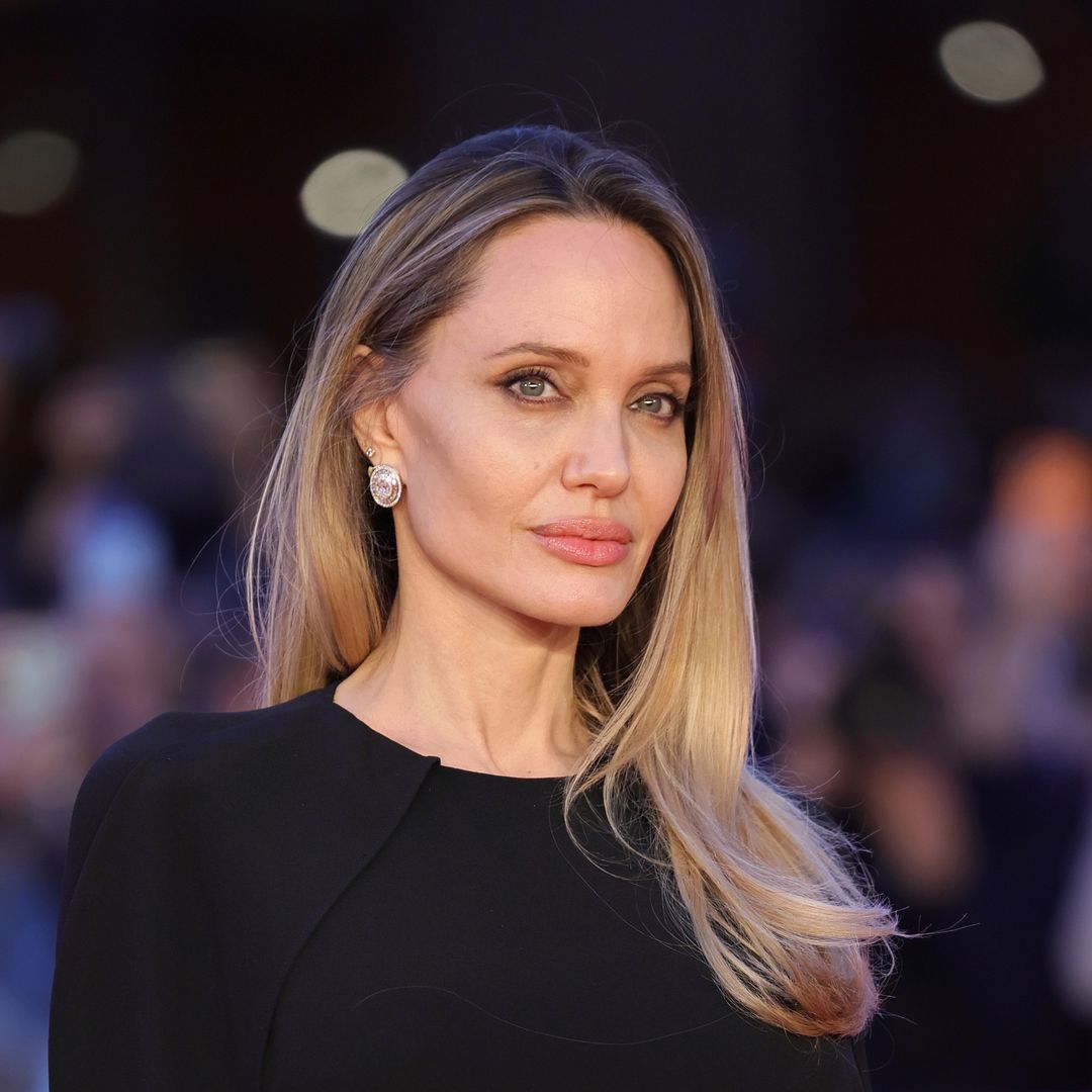 Angelina Jolie stuns in sleek white wrap dress and bold red lip at surprise Shanghai appearance